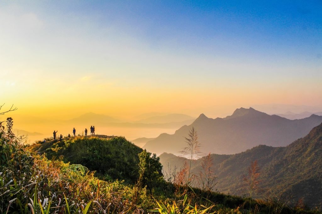 احجز مغامرتك الان Photo Of People Standing On Top Of Mountain Near Grasses 733162 1024x682 1